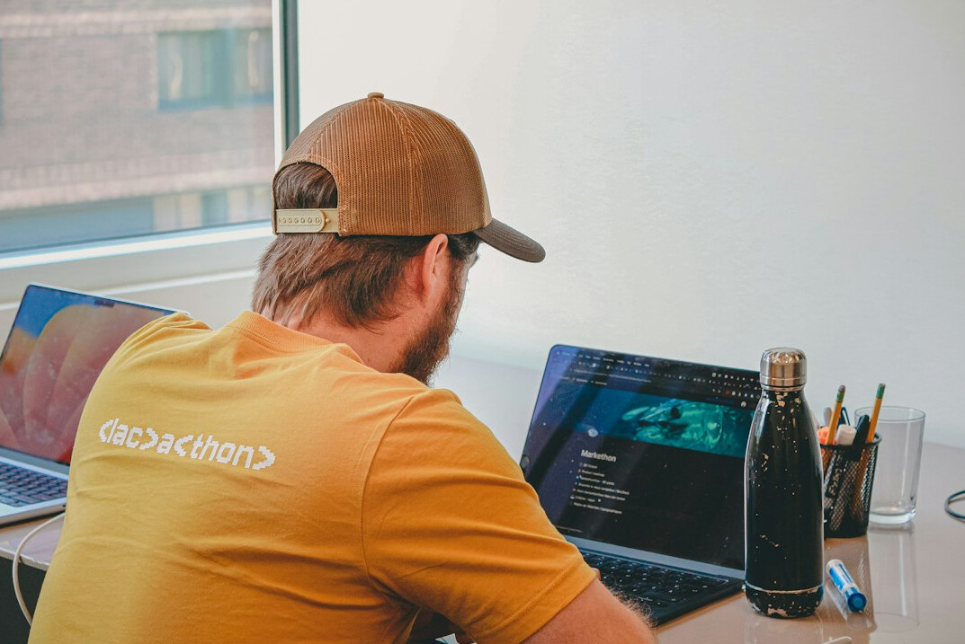 student coding on laptop