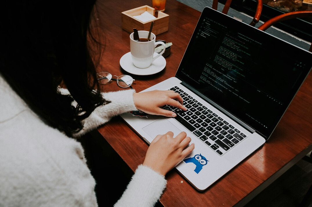 woman coding on laptop