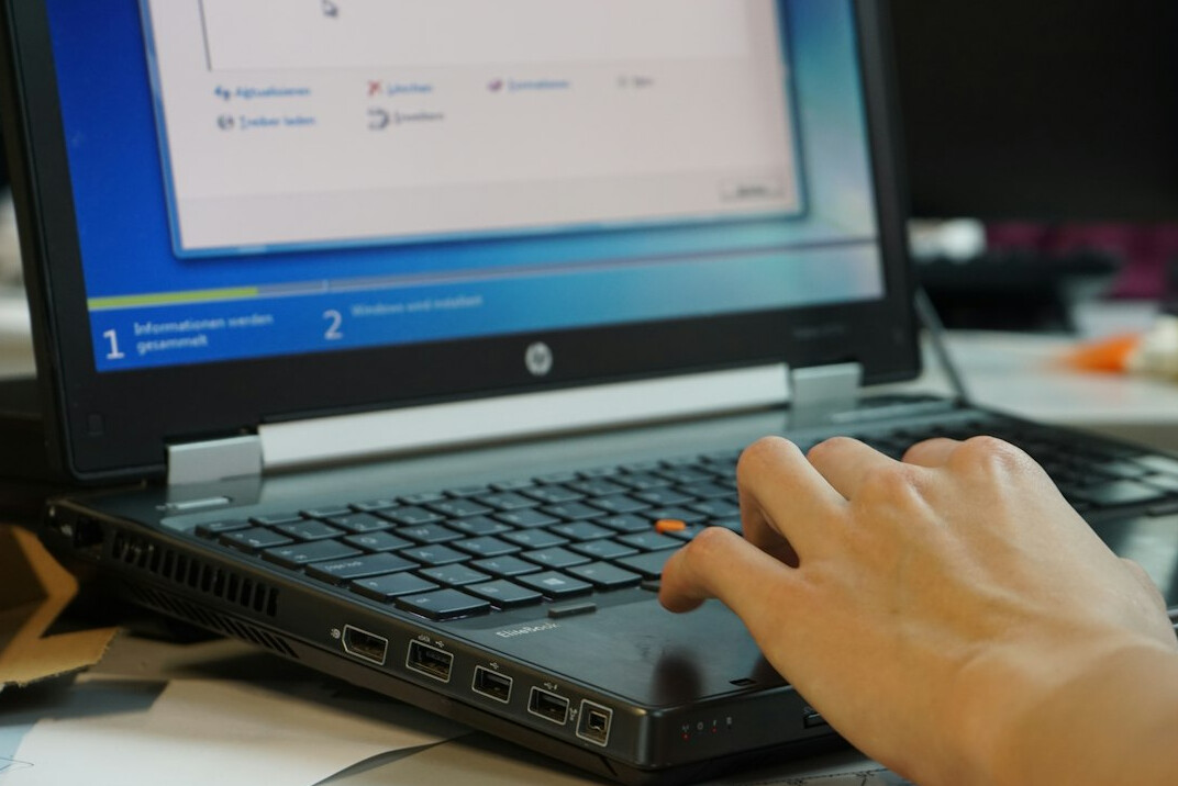 student coding on laptop